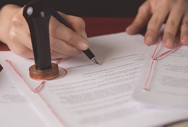 istock Close up on notaries public hand signing the testament 508624258
