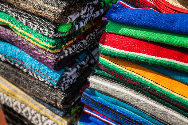 istock Colorful Mexican serapes hang in row. 508624348