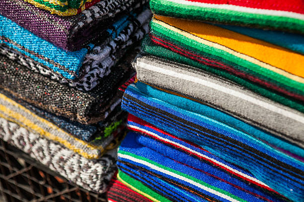 istock Colorful Mexican serapes hang in row. 508624380