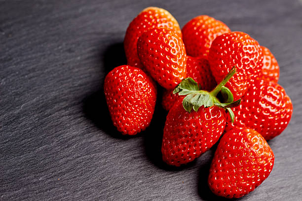 istock Strawberries on a black slate 508626046