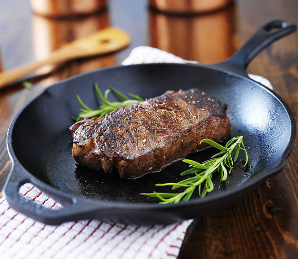 istock new york strip steak cooked in iron skillet 508626155