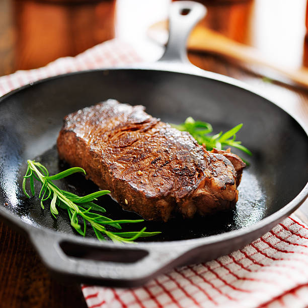 new york strip steak cooked in iron skillet