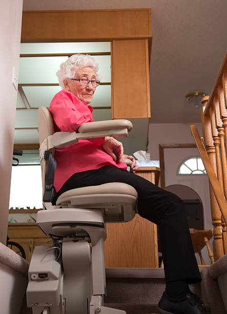 istock Elderly woman using stairlift: assisted living 508626924
