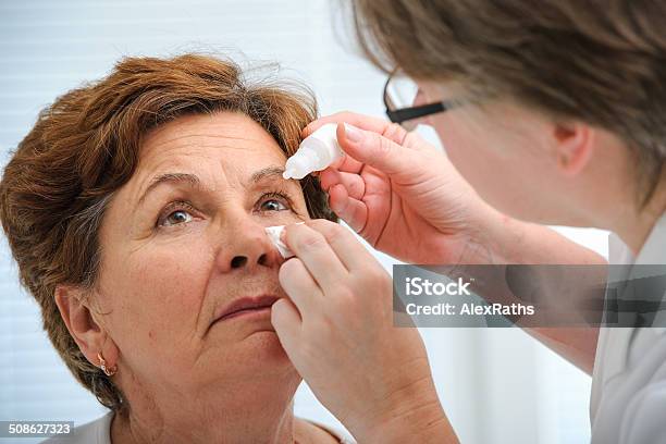 Senior Woman Applying Eye Drops Stock Photo - Download Image Now - Eyedropper, Eye, Senior Adult