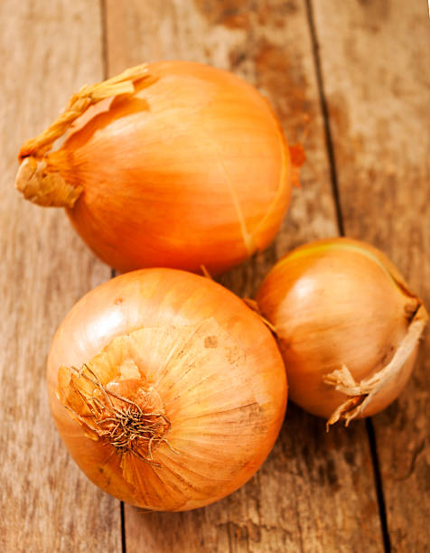 istock onion on wooden background 508627799
