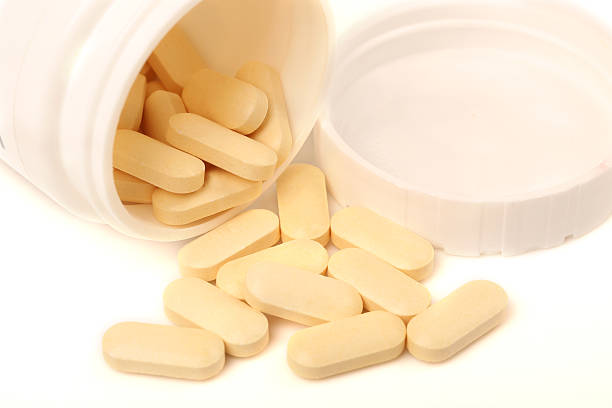 istock Medicine pills or capsules in bottle on white background. 508628418