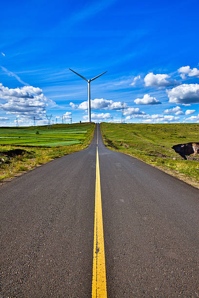 istock Power Generating Windmills and road 508628671