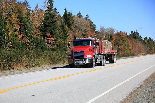 istock Semi truck hauling large rock on a highway 508629138