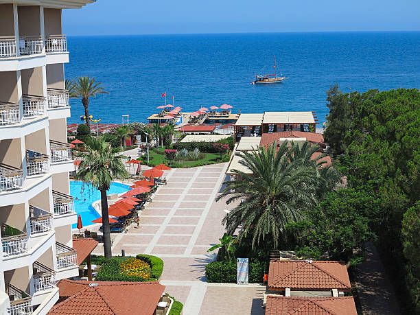 istock Luxurious hotel, palms, swimming pool and a ship on sea 508629691