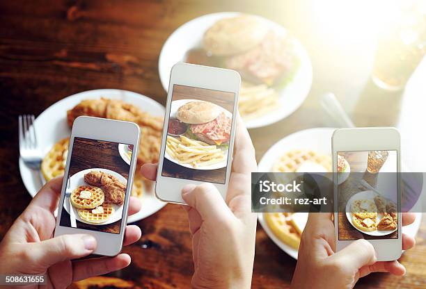 Friends Taking Photos Of Food With Smart Phones Stock Photo - Download Image Now - Auto Post Production Filter, Food, Chicken Meat