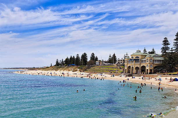 Perth Cottesloe beach pavilion day sunny day view of central pavilion building on Cottesloe western beach of Perth with swimming and relaxing people - beachgoers cottesloe stock pictures, royalty-free photos & images