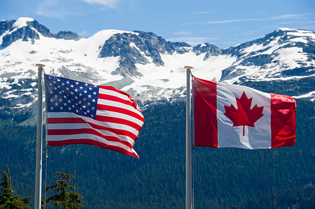 Canadian and American flags stock photo