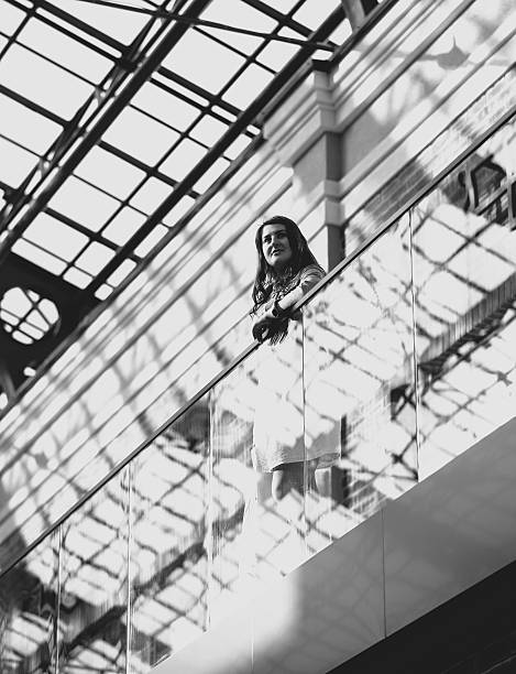 beautiful woman with shopping bag at duty free Black and white photo of beautiful woman with shopping bag at duty free train station black and white stock pictures, royalty-free photos & images