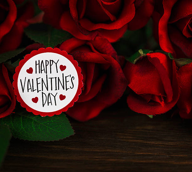 istock Valentine red rose bouquet on rustic wooden table with message 508632622