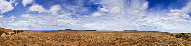 SA Plain 2 Pt Augusta 180 panorama wide 180 degrees panorama of endless plains in Australian outback on a summer sunny day. Fenced highway with flat distant hills on the horizon augusta precious metals location stock pictures, royalty-free photos & images