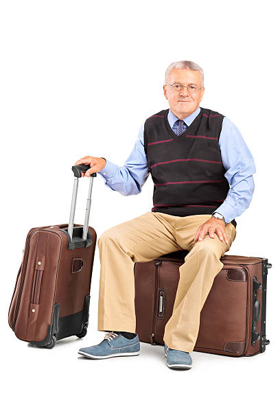 istock Senior man sitting on his baggage 508633393