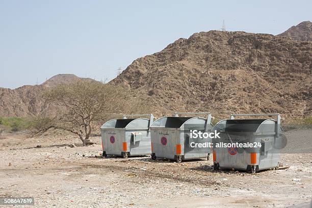 Rubbish Bins On Wasteground Dibba Uae Stock Photo - Download Image Now - Arabia, Arabic Script, Color Image