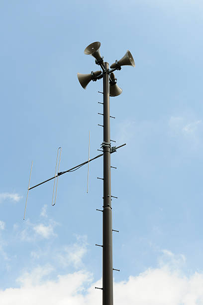 istock Loudspeakers with antenna against blue sky 508649097
