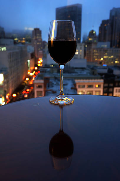 istock Wine vertical reflection on table in front of city 508650079
