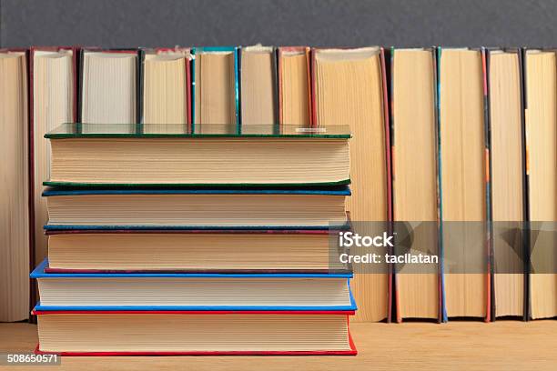 Pile Of Books On A Wooden Surface Stock Photo - Download Image Now - Book, Bookshelf, Bookstore