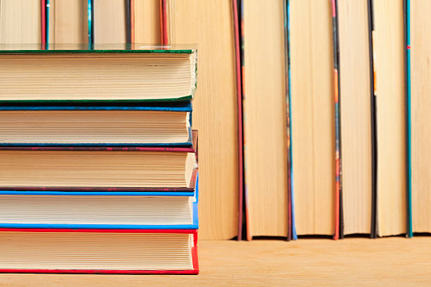istock Pile of books on a wooden surface. 508650575