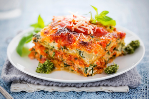 Lasagna with spinach, ricotta, red sauce, and parmesan cheese.