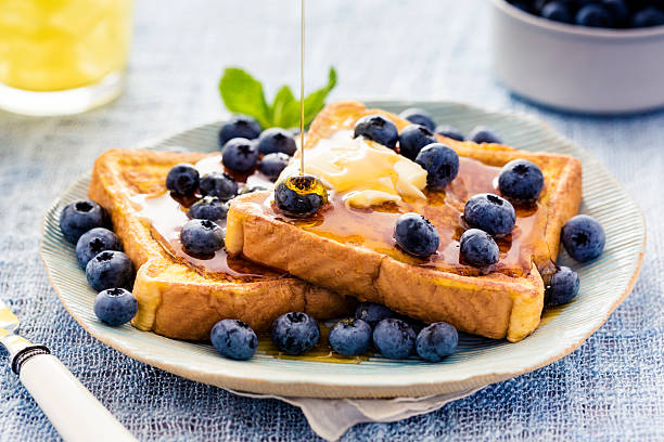 French Toast with Blueberries and Maple Syrup French toast flavored with blueberries, butter, mint and drizzled with maple syrup. french toast stock pictures, royalty-free photos & images