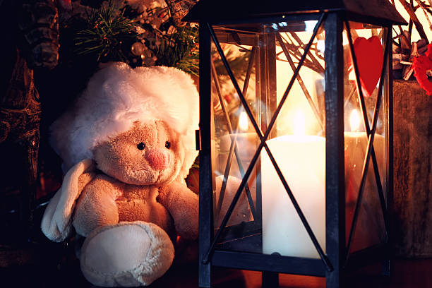 lonely toy near candle lamp