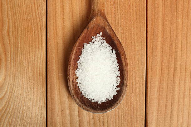 istock Salt on wooden spoon at plank background 508659536