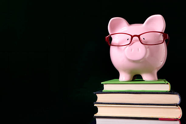 istock Piggy bank with glasses and blackboard 508660600
