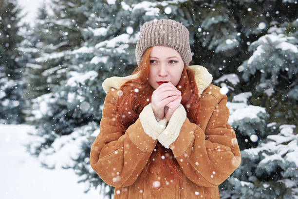 istock Young woman warms hands at winter 508660984