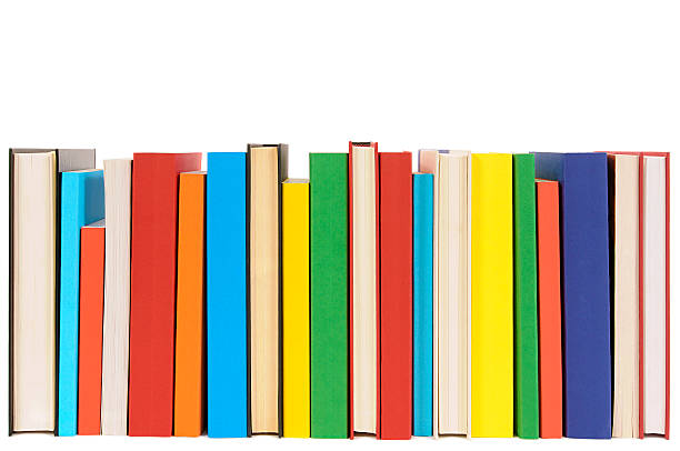 Row of colorful library books isolated on white background . Long row of colorful library books isolated on white background . rows of books stock pictures, royalty-free photos & images