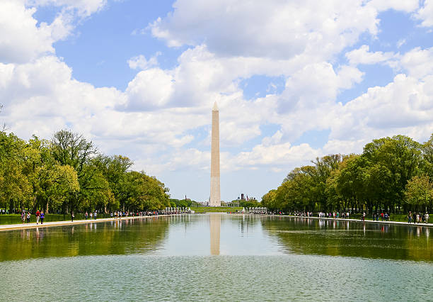 Reflecting Pool and Washington Monument Washington DC, USA - May 2, 2015: The Washington Monument seen from the Lincoln Memorial with the Reflecting Pool in front. washington monument reflecting pool stock pictures, royalty-free photos & images
