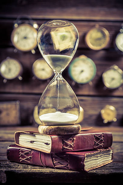 istock Vintage hourglass on the old books 508664822