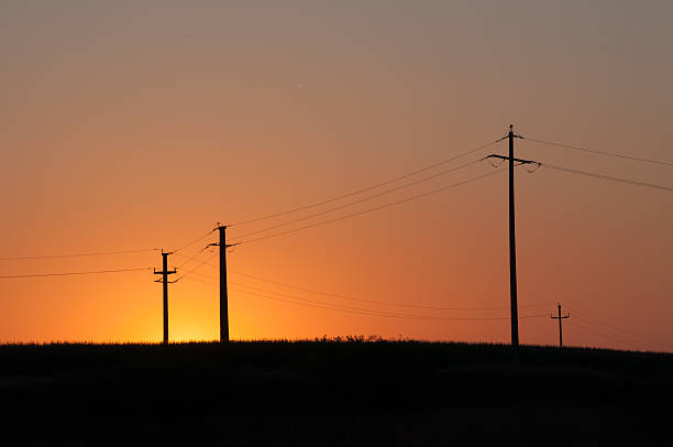 istock orange,yellow sunset and electric pylons 508667745