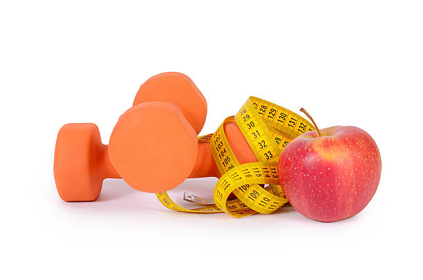 istock Measuring tape with dumbbells isolated 508668218