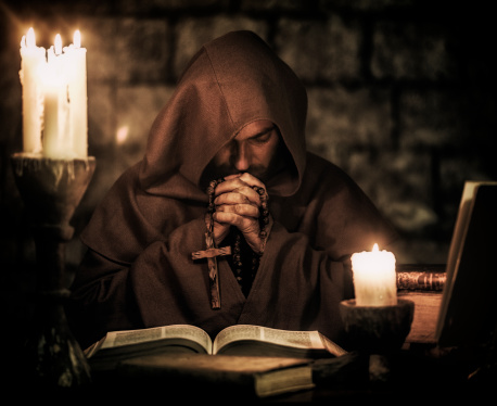 Monk praying inside monastery
