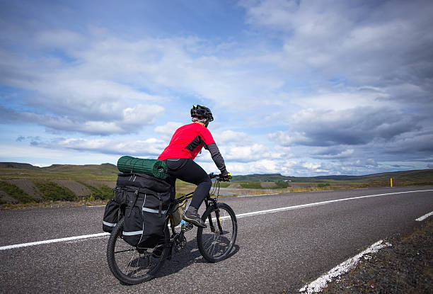 istock Biker rides on road at sunny summer day in Iceland 508668870
