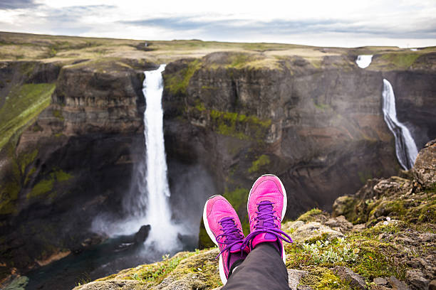 istock Woman's leg relax on cliff near fantastic waterfall 508669000