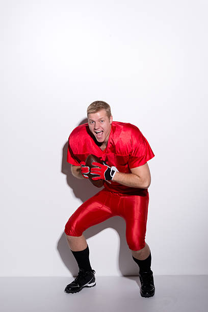 istock American football player holding ball & cheering 508670607