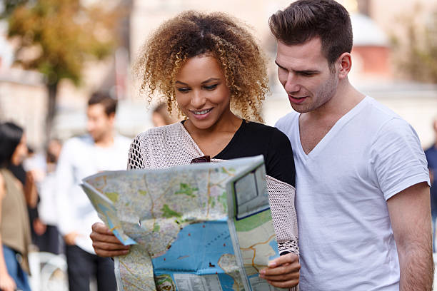 istock Happy tourists couple holding map 508671310
