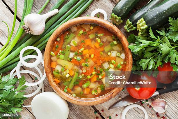 Vegetable Soup In Wooden Bowl And Ingredients On Table Stock Photo - Download Image Now