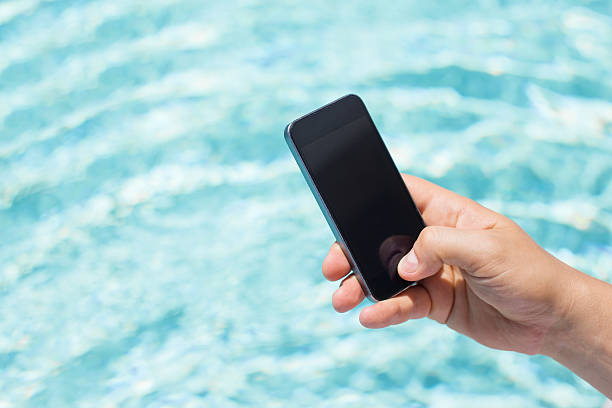 istock Mobile phone in hand by the pool 508671368