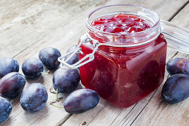 plums and jar of jam stock photo
