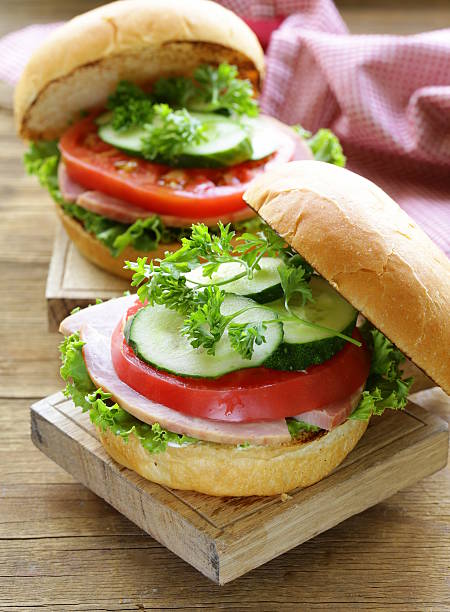 istock snack burger with fresh vegetables and ham on wooden board 508674479
