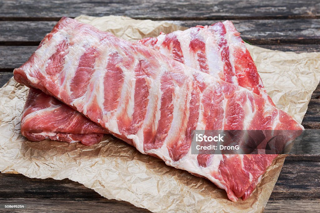 Raw Pork ribs. on crumpled paper Raw Fresh Pork ribs. on crumpled paper. Brown Stock Photo