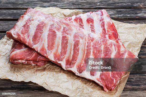 Raw Pork Ribs On Crumpled Paper Stock Photo - Download Image Now - Brown, Cooking, Cutting
