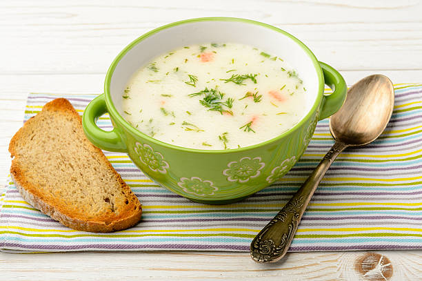 istock Cheese soup in green bowl on white wooden table. 508697062