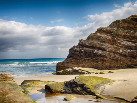 Soft wave of turquoise sea water on the sandy beach.