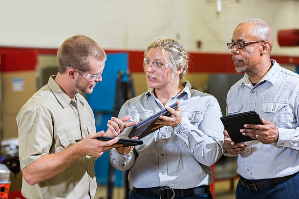istock Team of repairmen talking and looking at digital tablets 508701206